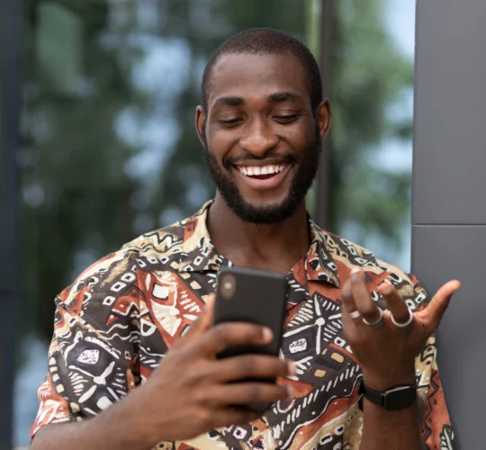 man smiling at phone